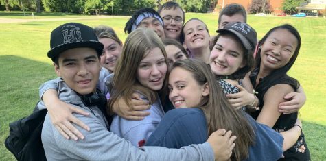 Group of students hug at camp 2019.